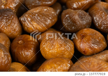 Golden brown texture of dried fruit, macro fig shot. Golden brown texture of dried fruit, macro fig shot. 137777919
