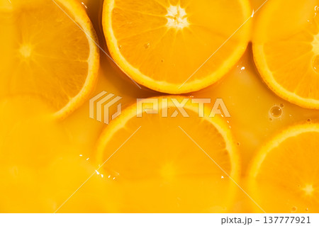 Orange slices swimming in fresh orange juice, horizontal macro. 137777921