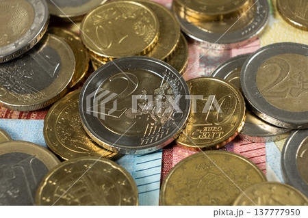 Close up of Euro coins on top of banknotes background. 137777950