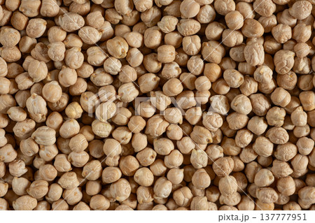 Raw uncooked chickpeas background top view. Raw uncooked chickpeas background top view. 137777951