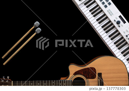 Music background with acoustic guitar, music keys and drum sticks, flat lay. Music background with acoustic guitar, music keys and drum sticks, flat lay. 137778303