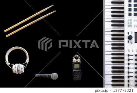 Music keys, headphones, recorder and microphone on a black background, flat lay. 137778321