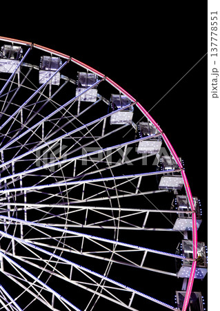 Ferris wheel in blue neon light on a dark background. Ferris wheel in blue neon light on a dark background. 137778551