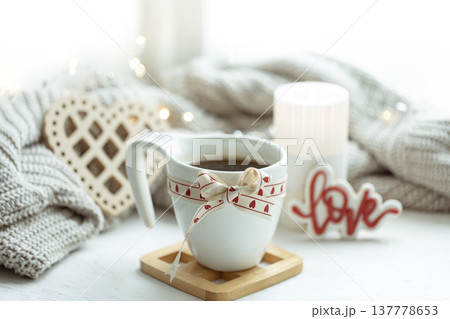 Festive composition with a cup and decor details for Valentine's Day. 137778653