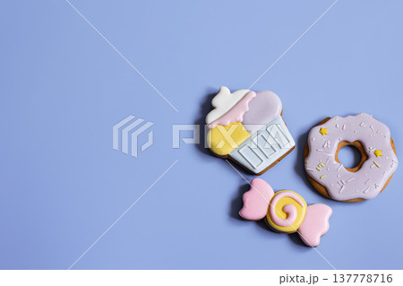 Colorful festive gingerbread cookies of different shapes covered with glaze. 137778716