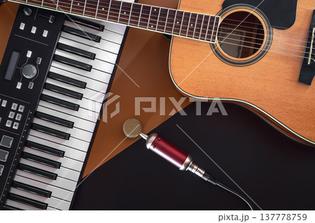 Flat lay, music background with acoustic guitar and piano. 137778759
