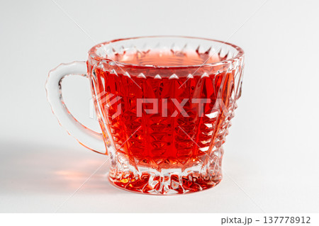 Glass cup with tea on a white background isolated. 137778912