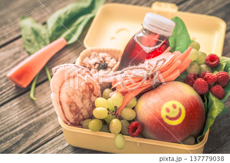 Breakfast or lunch with healthy food in a yellow box, on a wooden background. Breakfast or lunch with healthy food in a yellow box, on a wooden background. 137779038