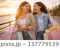 Happy Friends Shopping Together at Sunset by the River 137779539