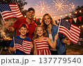 Happy Family Celebrating 4th of July with Fireworks and American Flags 137779540