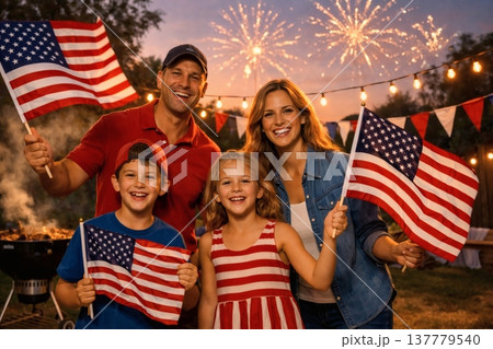 Happy Family Celebrating 4th of July with Fireworks and American Flags 137779540