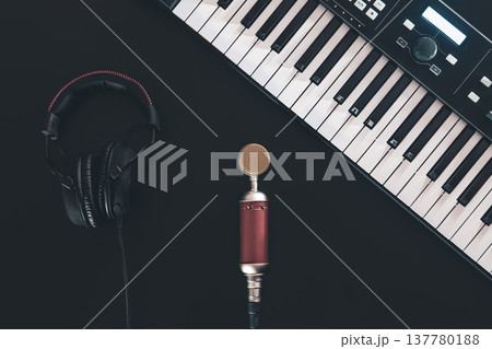 Piano keys, synthesizer on a black background, flat lay. 137780188
