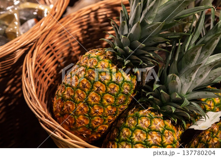 Pineapples fruit in a basket at the supermarket. Pineapples fruit in a basket at the supermarket. 137780204