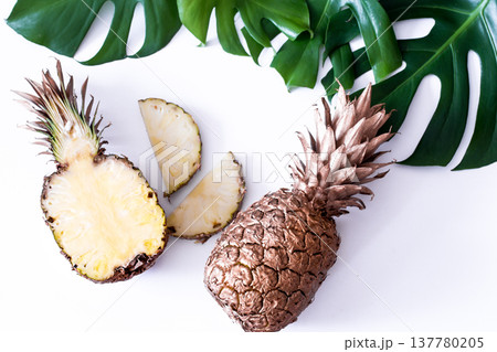 Pineapple with tropical leaves on white background Pineapple with tropical leaves on white background 137780205