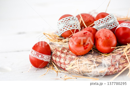Red Easter eggs in a nest of hay Red Easter eggs in a nest of hay 137780295