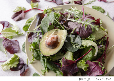 Salad of avocado and vegetables mixed greens lettuce leaves ready to eat. Salad of avocado and vegetables mixed greens lettuce leaves ready to eat. 137780392