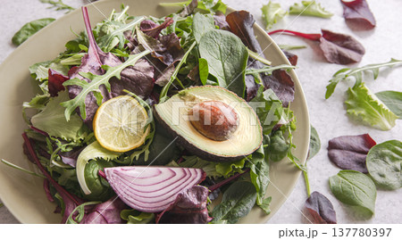 Salad of avocado and vegetables mixed greens lettuce leaves ready to eat. Salad of avocado and vegetables mixed greens lettuce leaves ready to eat. 137780397