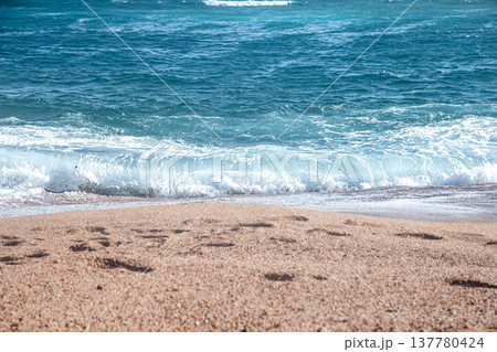 Seascape with turquoise waves with mountains on the horizon. Seascape with turquoise waves with mountains on the horizon. 137780424
