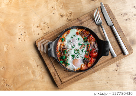 Shakshuka in fr rying pan. Eggs Poached in spicy tomato pepper sauce. Shakshuka in fr rying pan. Eggs Poached in spicy tomato pepper sauce. 137780430