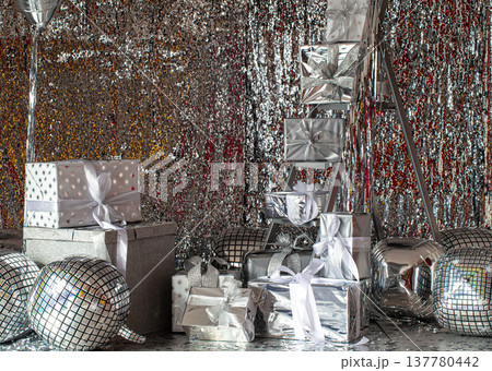 Silver festive Christmas boxes on a shiny background. Silver festive Christmas boxes on a shiny background. 137780442