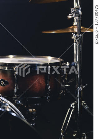 Snare drum on a blurred dark background, part of a drum kit. Snare drum on a blurred dark background, part of a drum kit. 137780475
