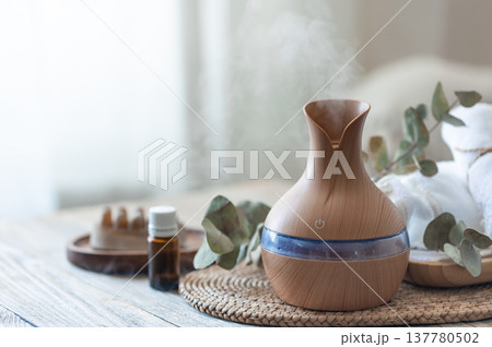 Spa composition with aroma oil diffuser lamp on a blurred background. Spa composition with aroma oil diffuser lamp on a blurred background. 137780502