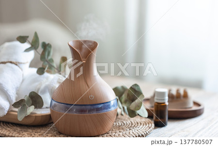 Spa composition with aroma oil diffuser lamp on a blurred background. Spa composition with aroma oil diffuser lamp on a blurred background. 137780507