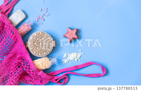 Spa composition with bath accessories in a pink string bag, flat lay. Spa composition with bath accessories in a pink string bag, flat lay. 137780513