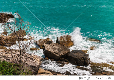 Rocky tropical coastline with waves crashing on granite stones, Koh Samui Thailand 137780950