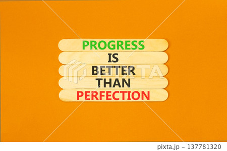 Progress or perfection words symbol. Concept words Progress is better than perfection on beautiful wooden sticks. Beautiful orange paper background. Business progress or perfection concept. Copy space Progress or perfection words symbol. Concept words Progress is better than perfection on beautiful wooden sticks. Beautiful orange paper background. Business progress or perfection concept. Copy space 137781320