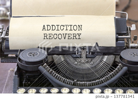 Addiction recovery symbol. Concept words Addiction recovery typed on beautiful old retro typewriter. Beautiful white paper background. Psychology addiction recovery concept. Copy space. 137781341