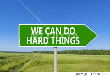 Support, help we can do hard things symbol. Concept words We can do hard things on beautiful green road sign. Beautiful blue sky field background. Business we can do hard things concept. Copy space. Support, help we can do hard things symbol. Concept words We can do hard things on beautiful green road sign. Beautiful blue sky field background. Business we can do hard things concept. Copy space. 137781358