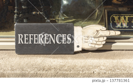References or reference symbol. Concept word References on beautiful black wooden sign as a hand. Beautiful store front background. Business references or reference concept. Copy space. 137781361