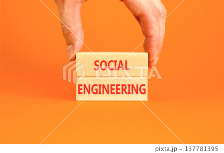 Social engineering words symbol. Concept words Social engineering on beautiful wooden blocks. Beautiful orange background. Businessman hand. Business and Social engineering words concept. Copy space. Social engineering words symbol. Concept words Social engineering on beautiful wooden blocks. Beautiful orange background. Businessman hand. Business and Social engineering words concept. Copy space. 137781395