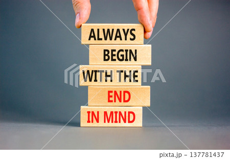 Begin with the end in mind symbol. Concept words Always begin with the end in mind on beautiful wooden blocks. Beautiful grey paper background. Business begin with the end in mind concept. Copy space. 137781437