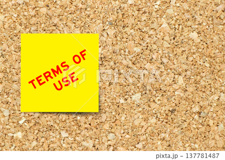 Yellow note paper with word terms of use on cork board background with copy space Yellow note paper with word terms of use on cork board background with copy space 137781487