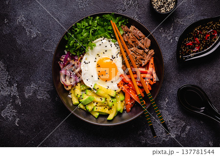 Traditional Korean dish Bibimbap: rice with vegetables beef and egg. 137781544