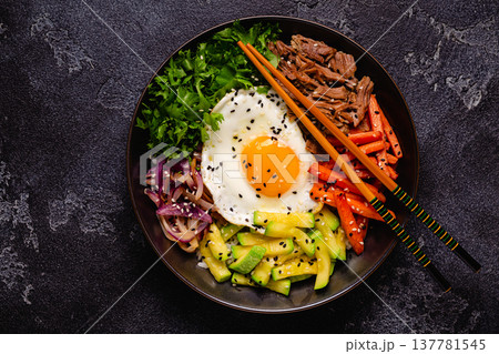Traditional Korean dish Bibimbap: rice with vegetables beef and egg. 137781545