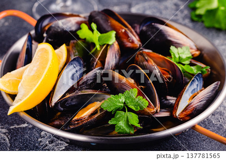 Delicious seafood mussels with sauce and parsley. Delicious seafood mussels with sauce and parsley. 137781565