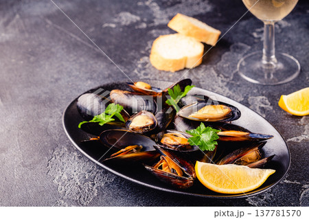 Delicious seafood mussels with sauce and parsley. 137781570