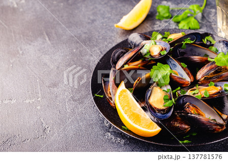 Delicious seafood mussels with sauce and parsley. 137781576