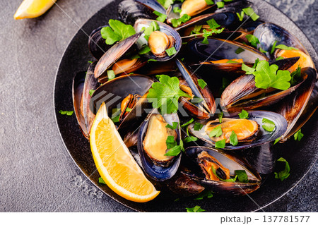 Delicious seafood mussels with sauce and parsley. Delicious seafood mussels with sauce and parsley. 137781577