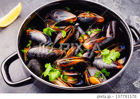 Delicious seafood mussels with sauce and parsley. Delicious seafood mussels with sauce and parsley. 137781578