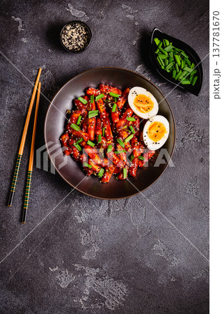 Tteokbokki, Teopokki fried rice cake in black bowl. Tteokbokki, Teopokki fried rice cake in black bowl. 137781670