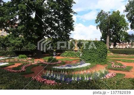 Russia, St. Petersburg, Peterhof, June 8, 2019. The photo shows the Monplaisir complex in the Lower Park of the Peterhof State Museum-Reserve and people who walk in the park. Russia, St. Petersburg, Peterhof, June 8, 2019. The photo shows the Monplaisir complex in the Lower Park of the Peterhof State Museum-Reserve and people who walk in the park. 137782039
