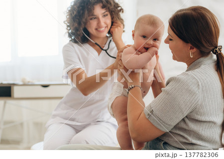 Mother with her baby girl is at doctor's appointment 137782306