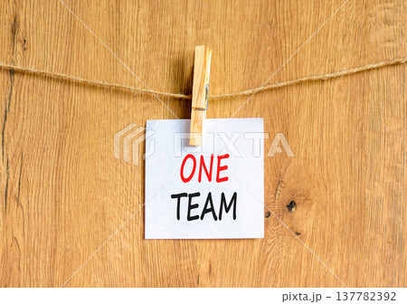 One team symbol. Concept word One team on beautiful white paper. Beautiful wooden clothespin. Beautiful wooden background. Business one team concept. Copy space. One team symbol. Concept word One team on beautiful white paper. Beautiful wooden clothespin. Beautiful wooden background. Business one team concept. Copy space. 137782392