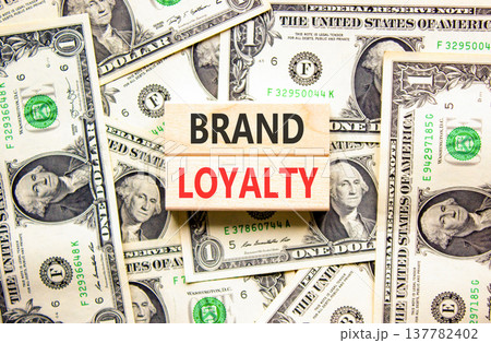 Brand loyalty words symbol. Concept words Brand loyalty on beautiful wooden blocks. Beautiful dollar bills background. Dollar bills. Business and Brand loyalty words concept. Copy space. Brand loyalty words symbol. Concept words Brand loyalty on beautiful wooden blocks. Beautiful dollar bills background. Dollar bills. Business and Brand loyalty words concept. Copy space. 137782402