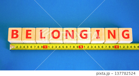 Belonging symbol. Concept words Belonging on beautiful wooden blocks. Beautiful blue background. Beautiful yellow ruler. Business support belonging concept. Copy space. Belonging symbol. Concept words Belonging on beautiful wooden blocks. Beautiful blue background. Beautiful yellow ruler. Business support belonging concept. Copy space. 137782524