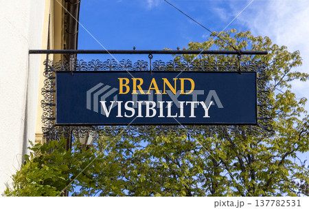 Brand visibility symbol. Concept words Brand visibility on beautiful big black road sign. Beautiful blue sky green trees background. Business branding and brand visibility concept. Copy space. Brand visibility symbol. Concept words Brand visibility on beautiful big black road sign. Beautiful blue sky green trees background. Business branding and brand visibility concept. Copy space. 137782531